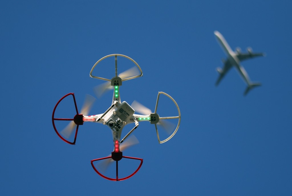 OLD BETHPAGE, NY - SEPTEMBER 05: A drone is flown for recreational purposes as an airplane passes nearby in the sky above Old Bethpage, New York on September 5, 2015. (Photo by Bruce Bennett/Getty Images)