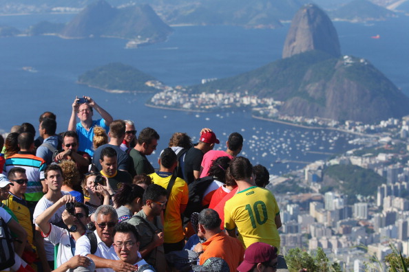 RIO DE JANEIRO, BRAZIL - JUNE 09: Tourists take photos of the view by the Christ Redeemer Statue on June 9, 2014 in Rio de Janeiro, Brazil. (Photo by Julian Finney/Getty Images)