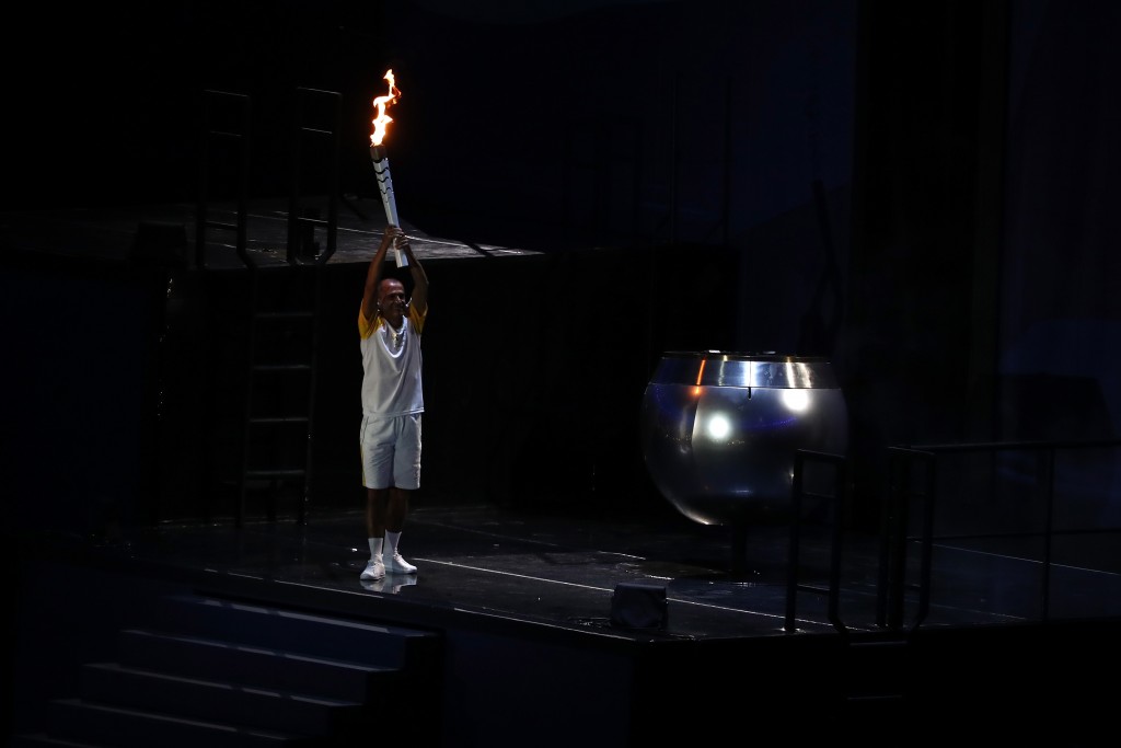 RIO DE JANEIRO, BRAZIL - AUGUST 05: Former athlete Vanderlei de Lima carries the Olympic Torch during the Opening Ceremony of the Rio 2016 Olympic Games at Maracana Stadium on August 5, 2016 in Rio de Janeiro, Brazil. (Photo by Clive Mason/Getty Images)